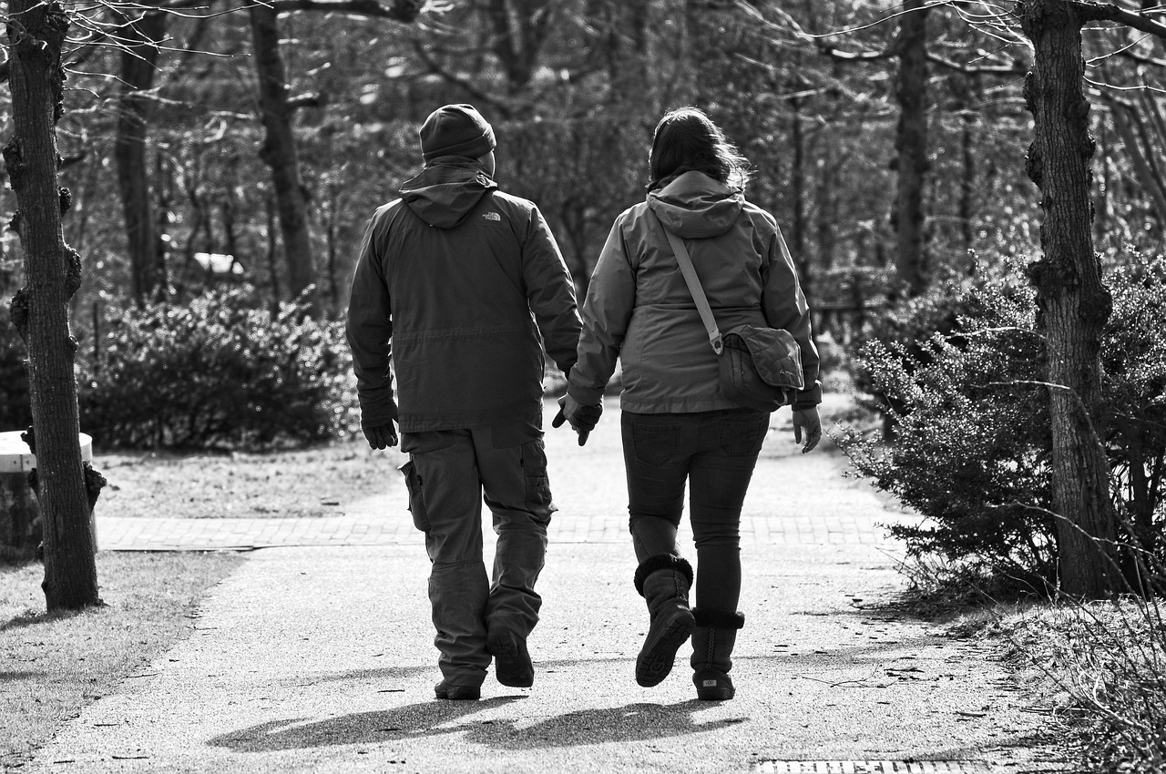 Man, woman, persons, people, couple, together, two, man and woman, hands, holding hands, walking, moving, motions, exercise, footpath, sunny day, male, female, adult, gray exercise, gray walking, gray