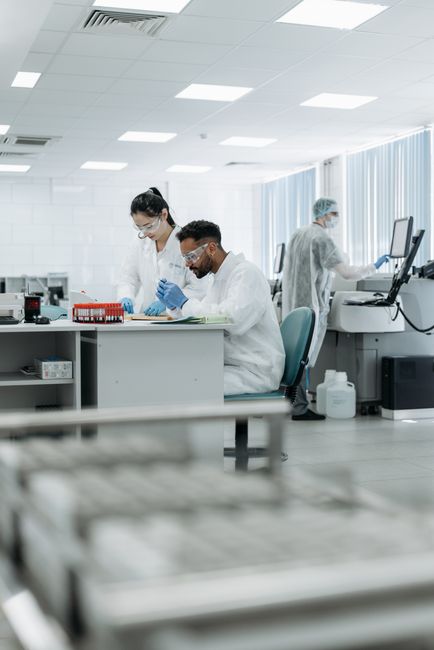 Scientists in a high-tech lab conducting research, analyzing data with advanced equipment.