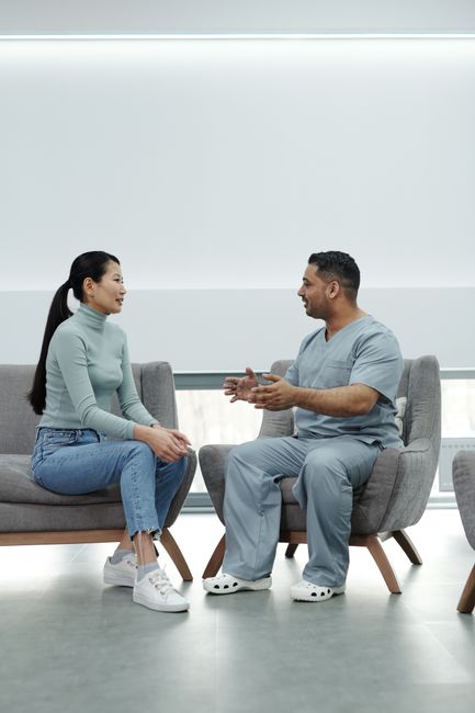 A doctor consults with a patient in a modern, well-lit clinic environment.