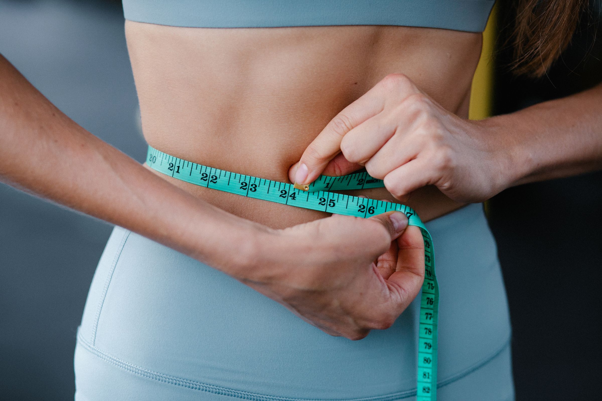 Close-up of a tape measure around a slim waist