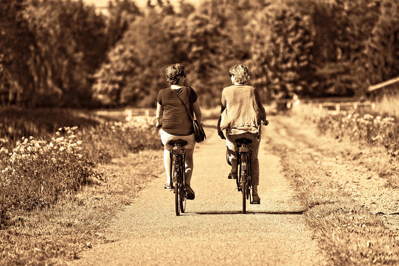 Person, woman, together, two women, two, friends, two friends, side by side, cycling, track, cycling track, exercise, motion, moving, destination, transport, sunny day, friends, friends, friends, frie
